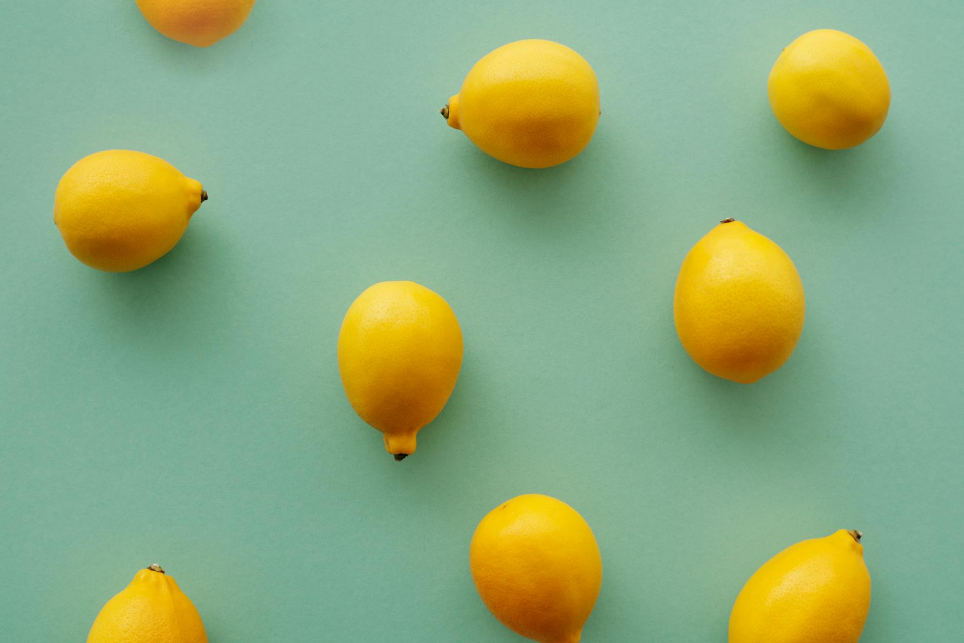 Bright yellow lemons arranged on a pastel background, symbolizing fresh starts and renewal