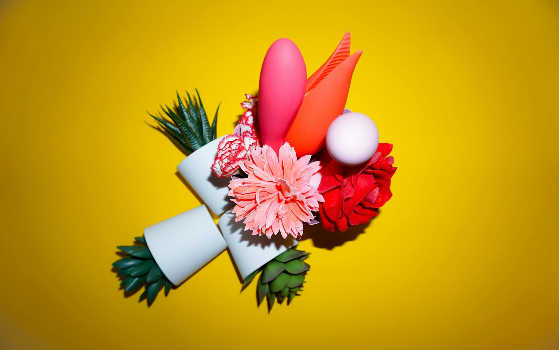 Colorful arrangement of flowers and abstract objects on a bright yellow background representing renewal and reconnection.